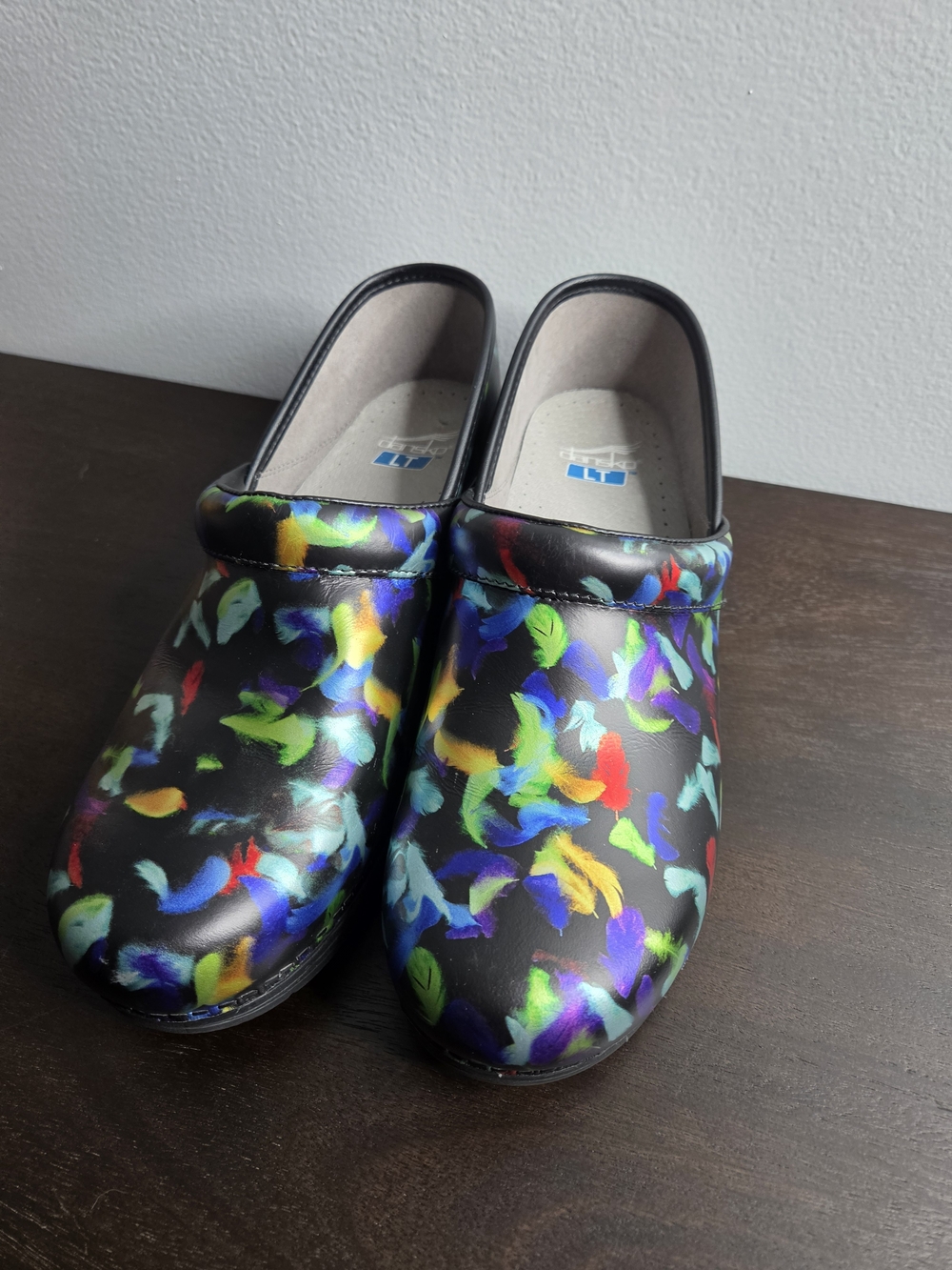 Dansko Black Clogs with Multicolor Feather Pattern